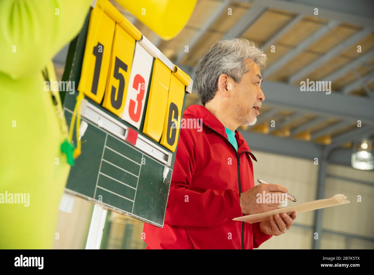 Senior man standing by score board Stock Photo