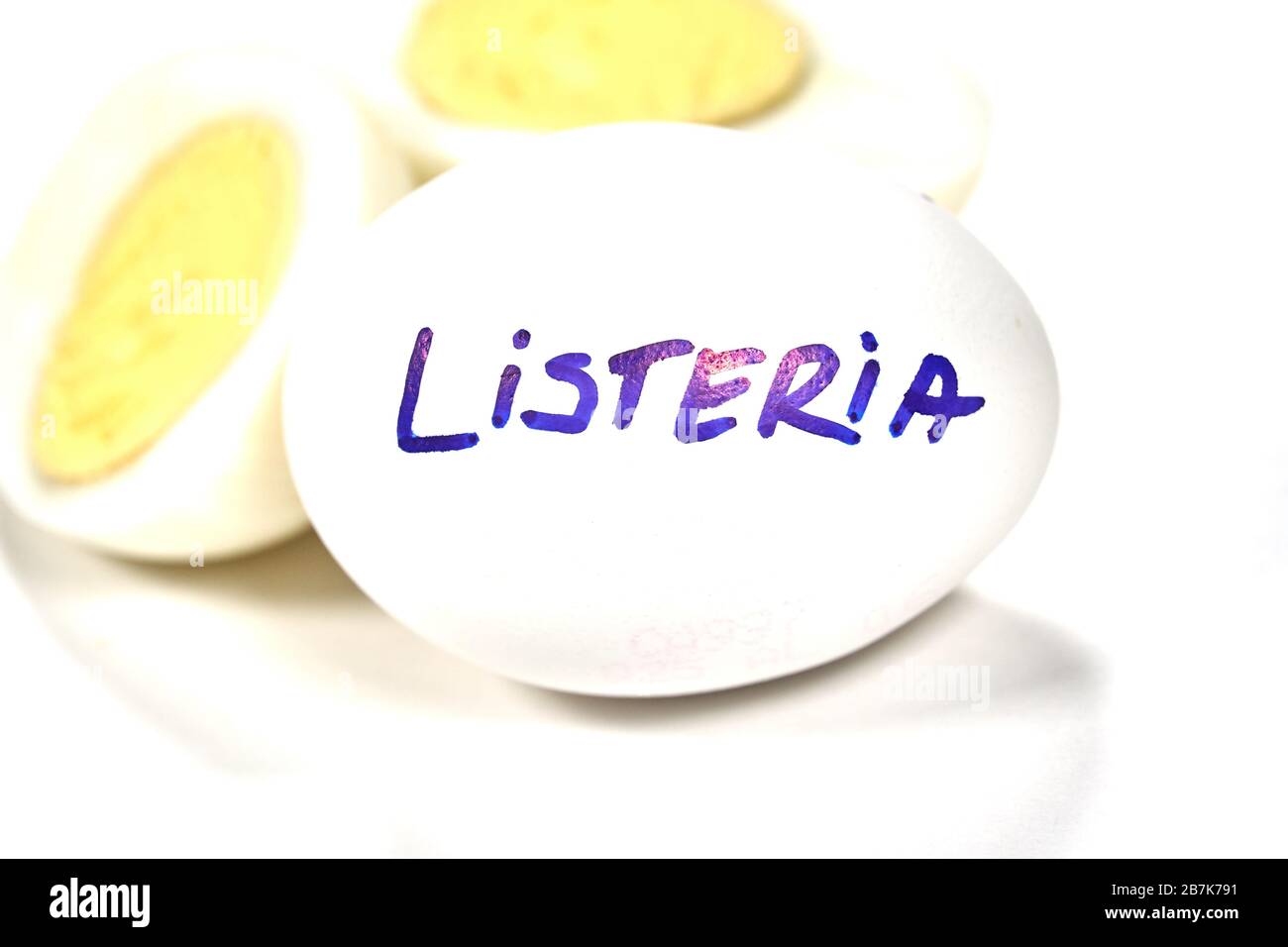Hard boiled egg with Listeria writing on egg. Listeriosis is a food-borne infection caused by Listeria bacteria. Listeria is caused by bacteria that c Stock Photo