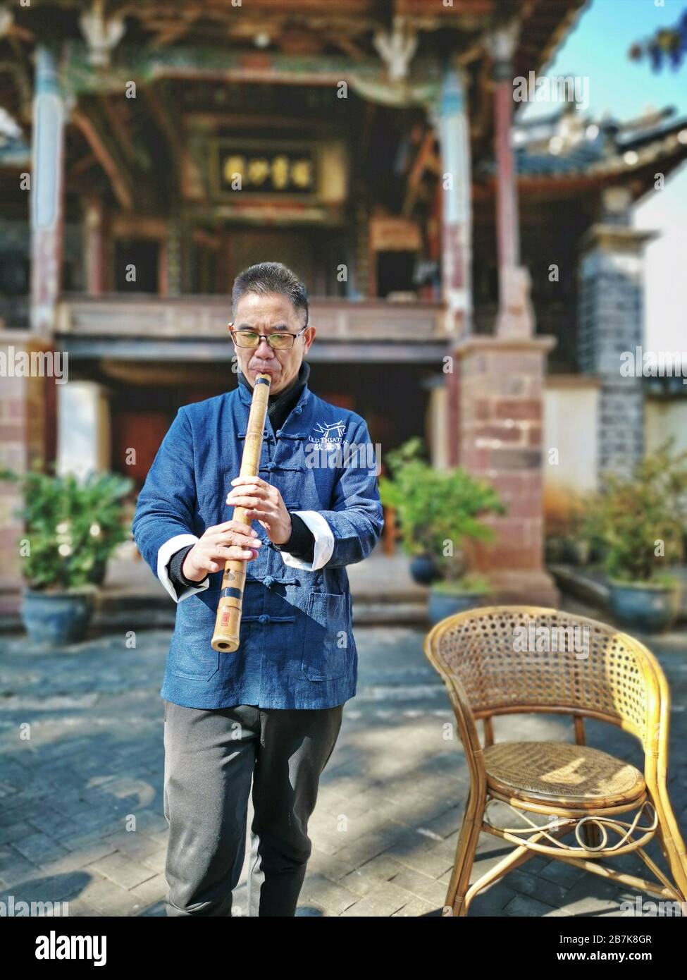 Traditional musician - Old Theatre Inn Shaxi Yunnan China Stock Photo