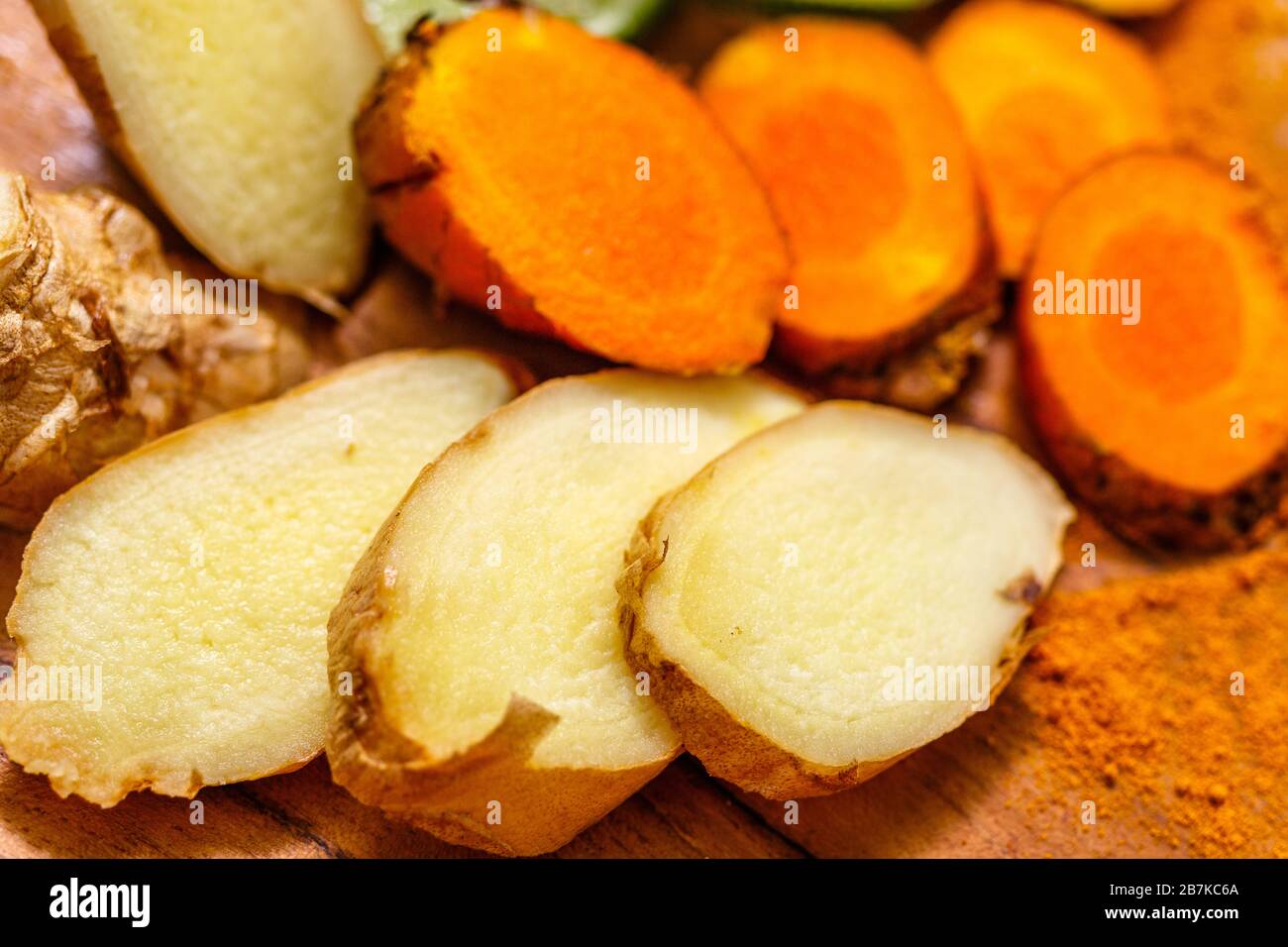 Sliced ginger root (Zingiber officinale) and  turmeric root (Curcuma longa). Stock Photo