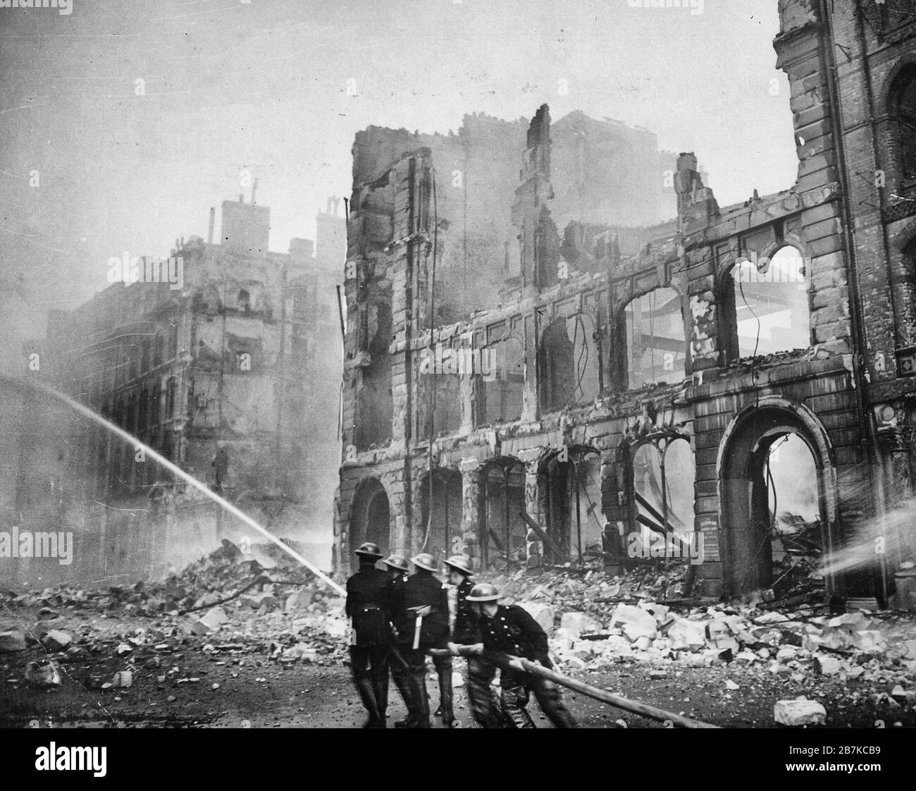 Firefighters putting out a blaze in London after an air raid during The Blitz in 1941. Stock Photo