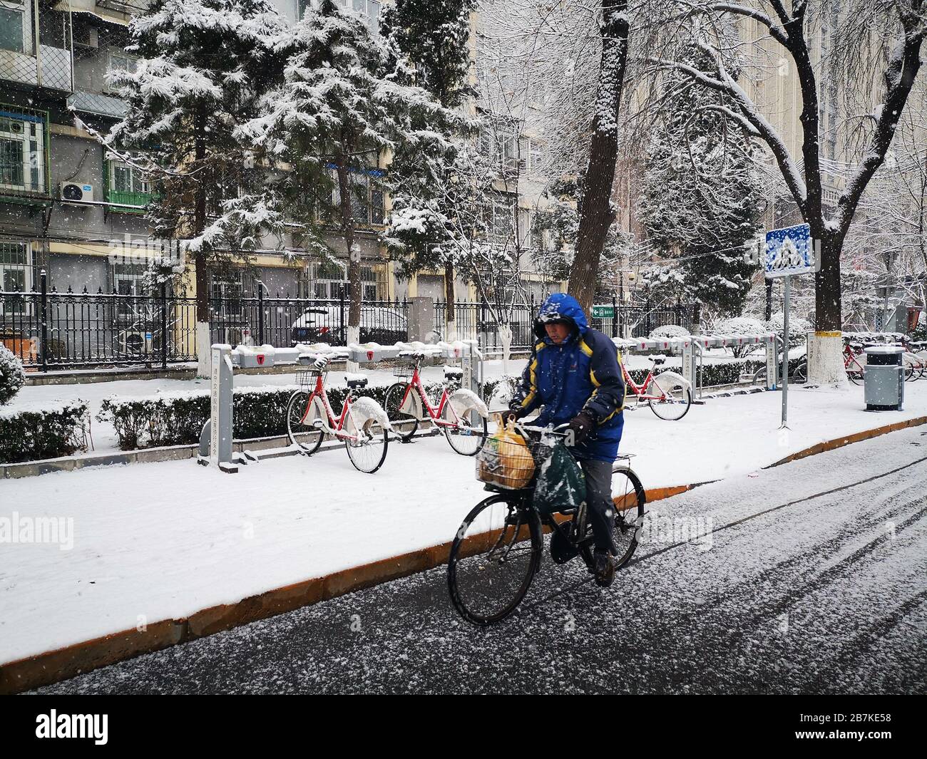 Citizen in the very first snow of year of rat, Beijing, China, 2 ...