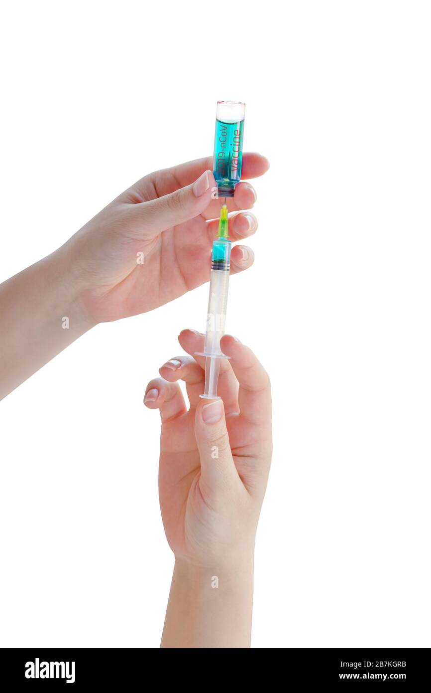 Ampoule with vaccine from a new coronavirus and syringe in a woman hand isolated on white background. Flu vaccination concept. COVID-19. 2019 Novel Co Stock Photo
