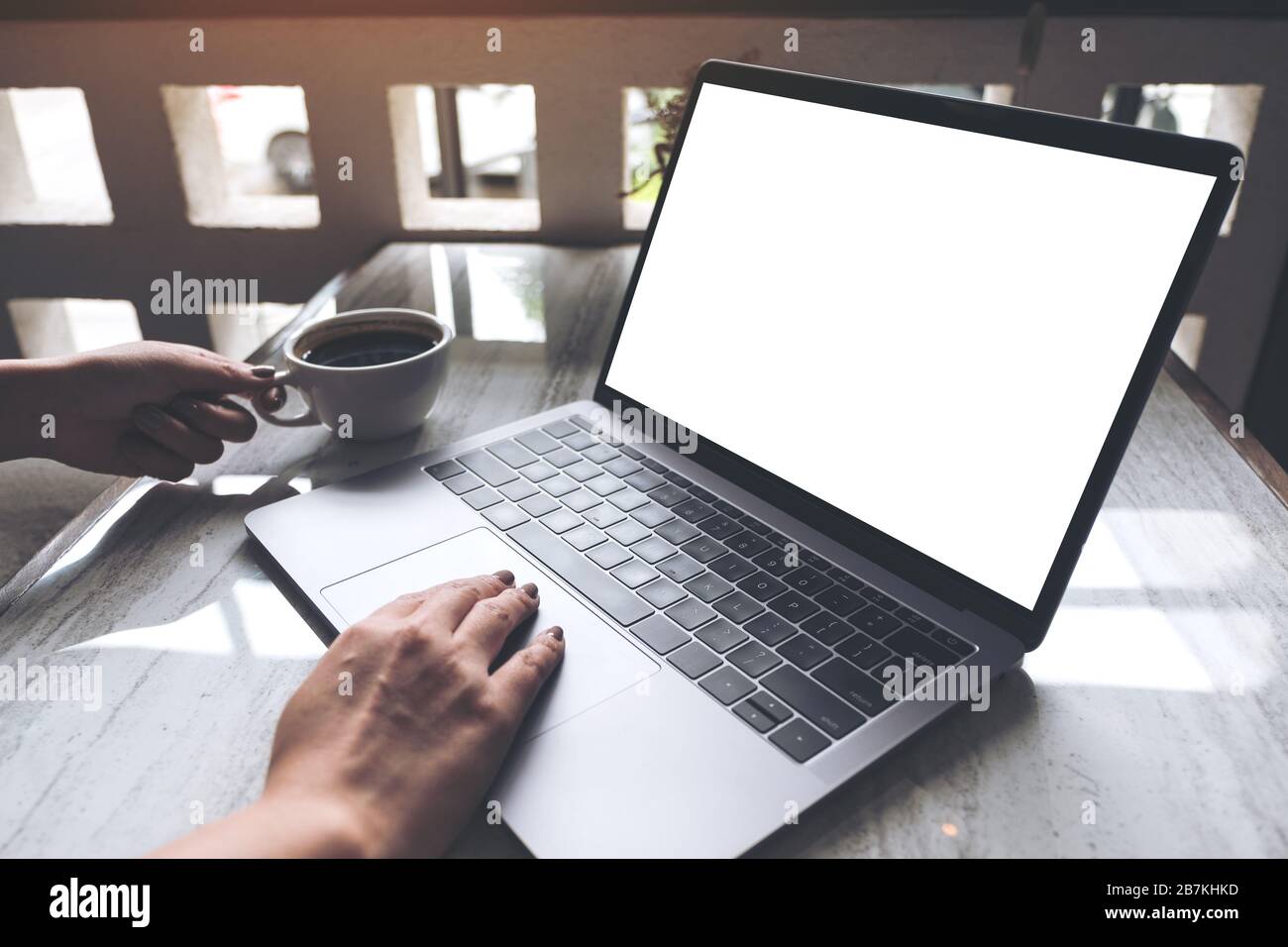 Mockup image of a woman using and typing on laptop with blank white ...