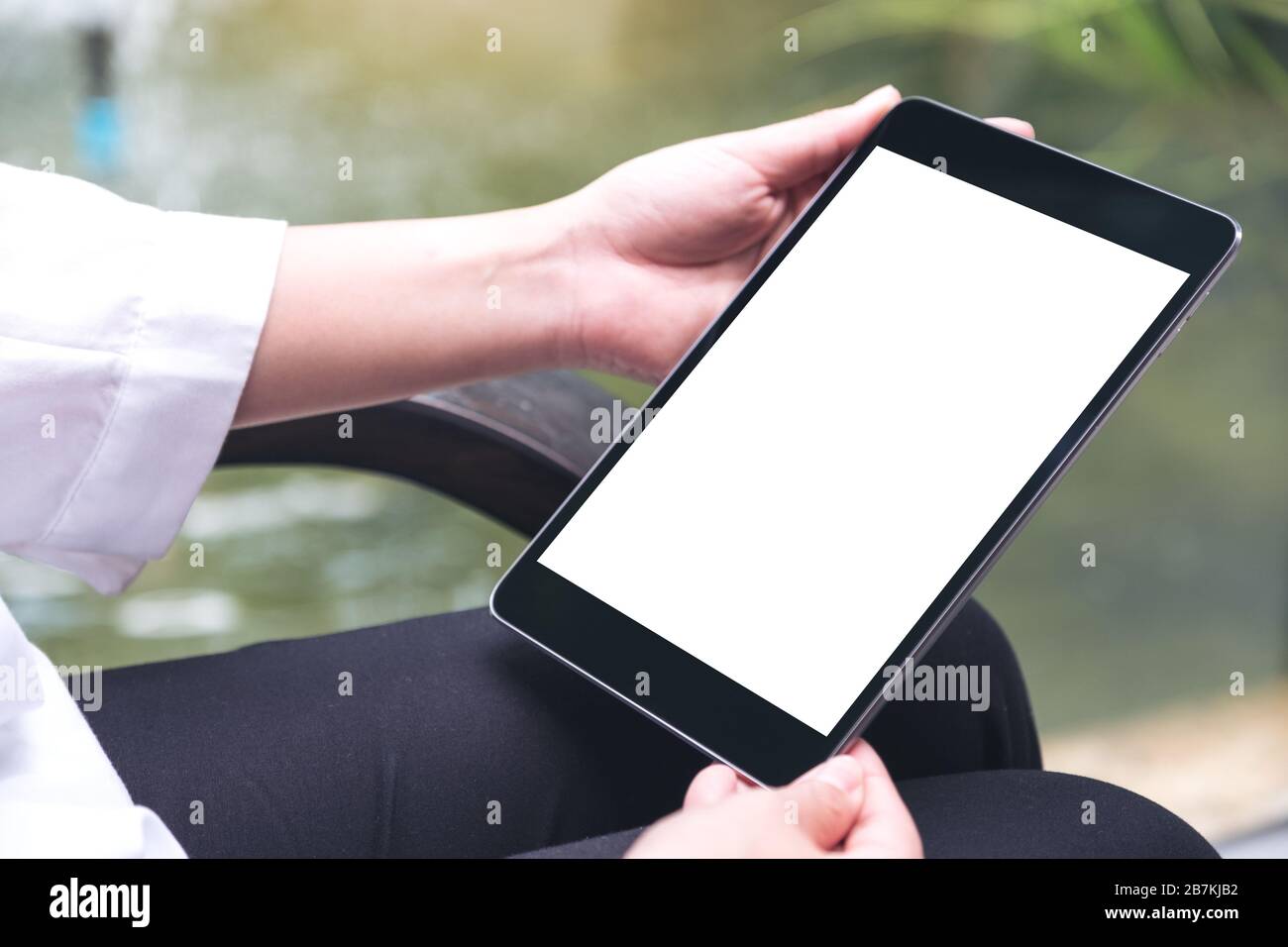 Mockup image of woman's hands holding black tablet pc with blank white ...
