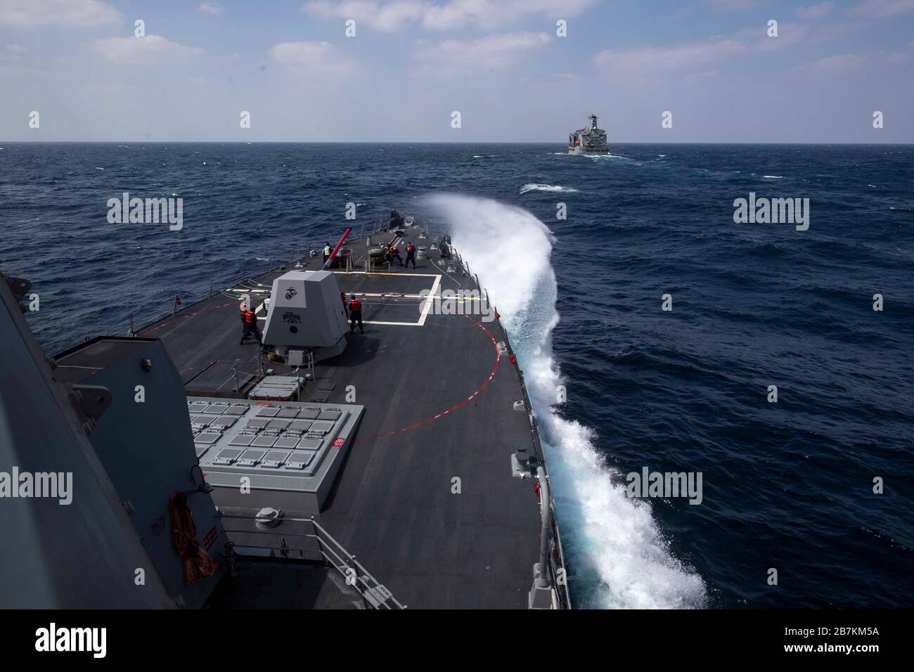 PACIFIC OCEAN (March 11, 2020) The Arleigh Burke-class guided-missile destroyer USS Rafael Peralta (DDG 115) approaches the fleet replenishment oiler USNS Tippecanoe (T-AO 199) for a replenishment-at-sea March 11, 2020. Rafael Peralta, part of the Theodore Roosevelt Carrier Strike Group, is on a scheduled deployment to the Indo-Pacific. (U.S. Navy photo by Mass Communication Specialist 2nd Class Jason Isaacs) Stock Photo