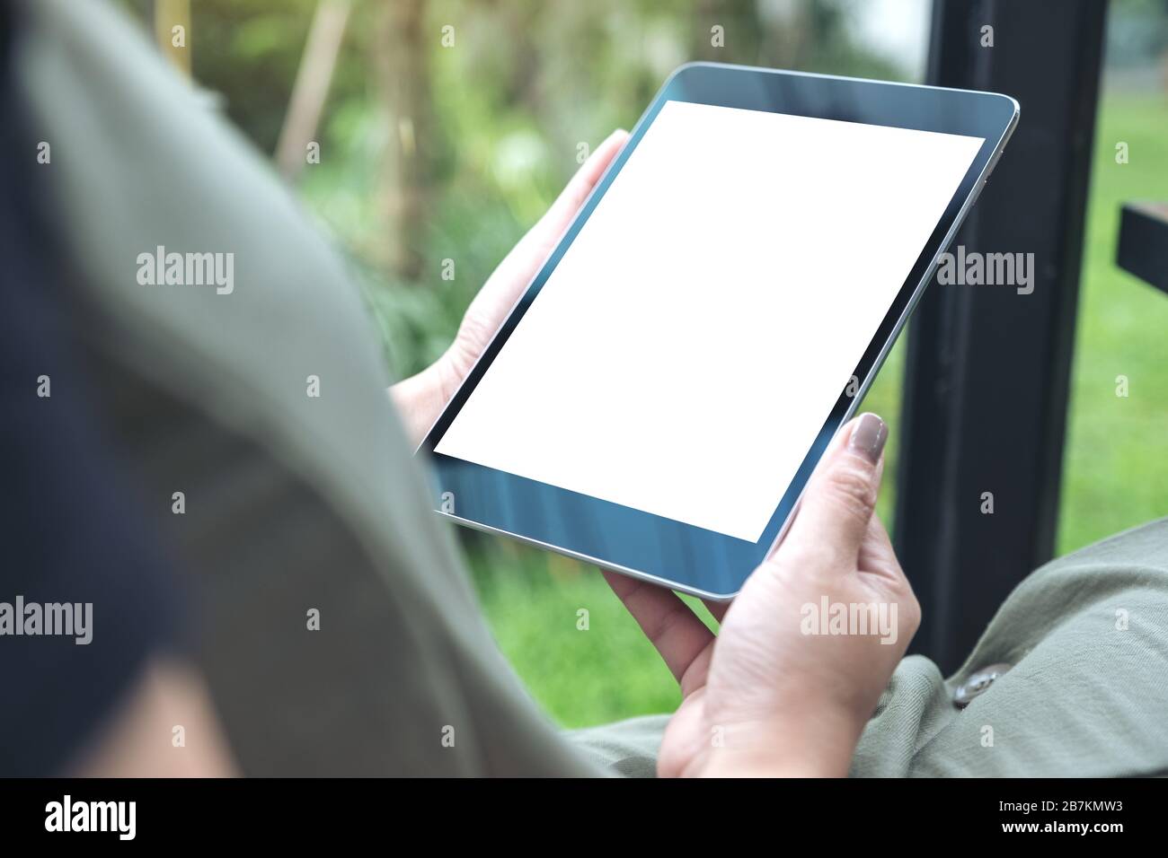 Mockup image of woman's hands holding black tablet pc with white blank ...