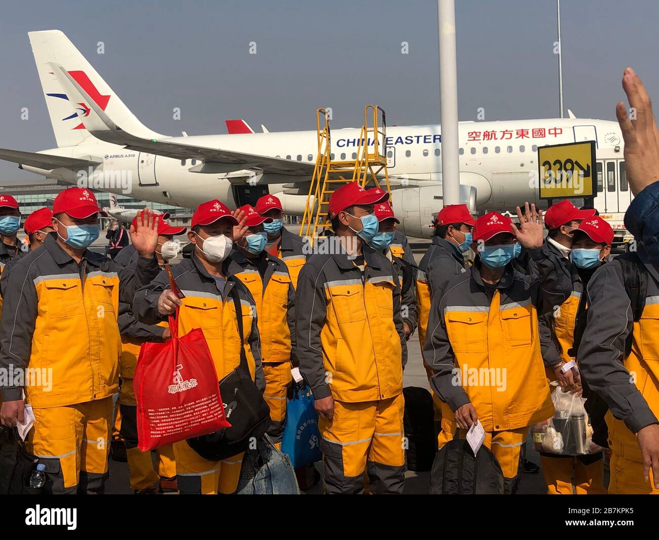 Returning work personnel from Shaanxi province line up to get on a customed airplane of China Eastern at the Xi'an Xianyang International Airport in X Stock Photo