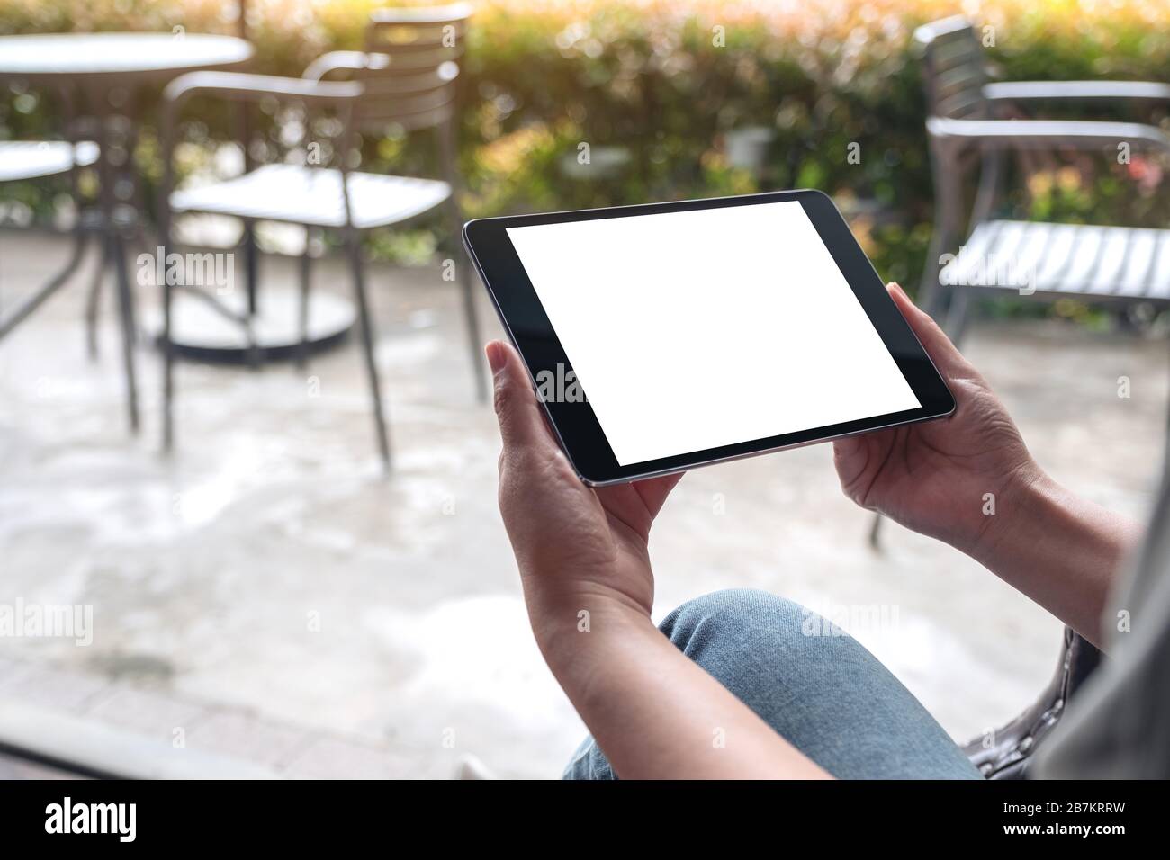 Mockup image of woman's hands holding black tablet pc with white blank ...