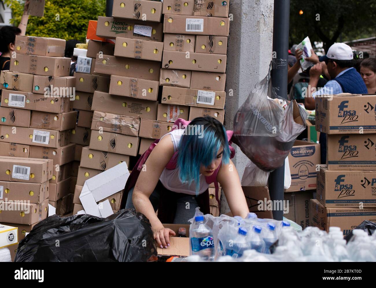 Volunteers help package supplies at the Red Cross in Mexico City Stock Photo