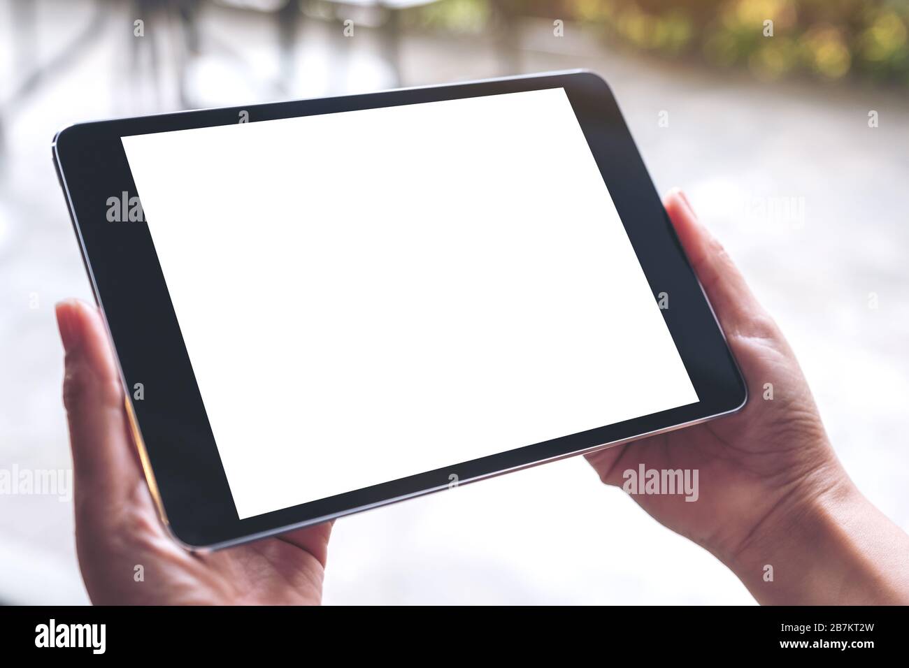 Mockup image of woman's hands holding black tablet pc with white blank ...