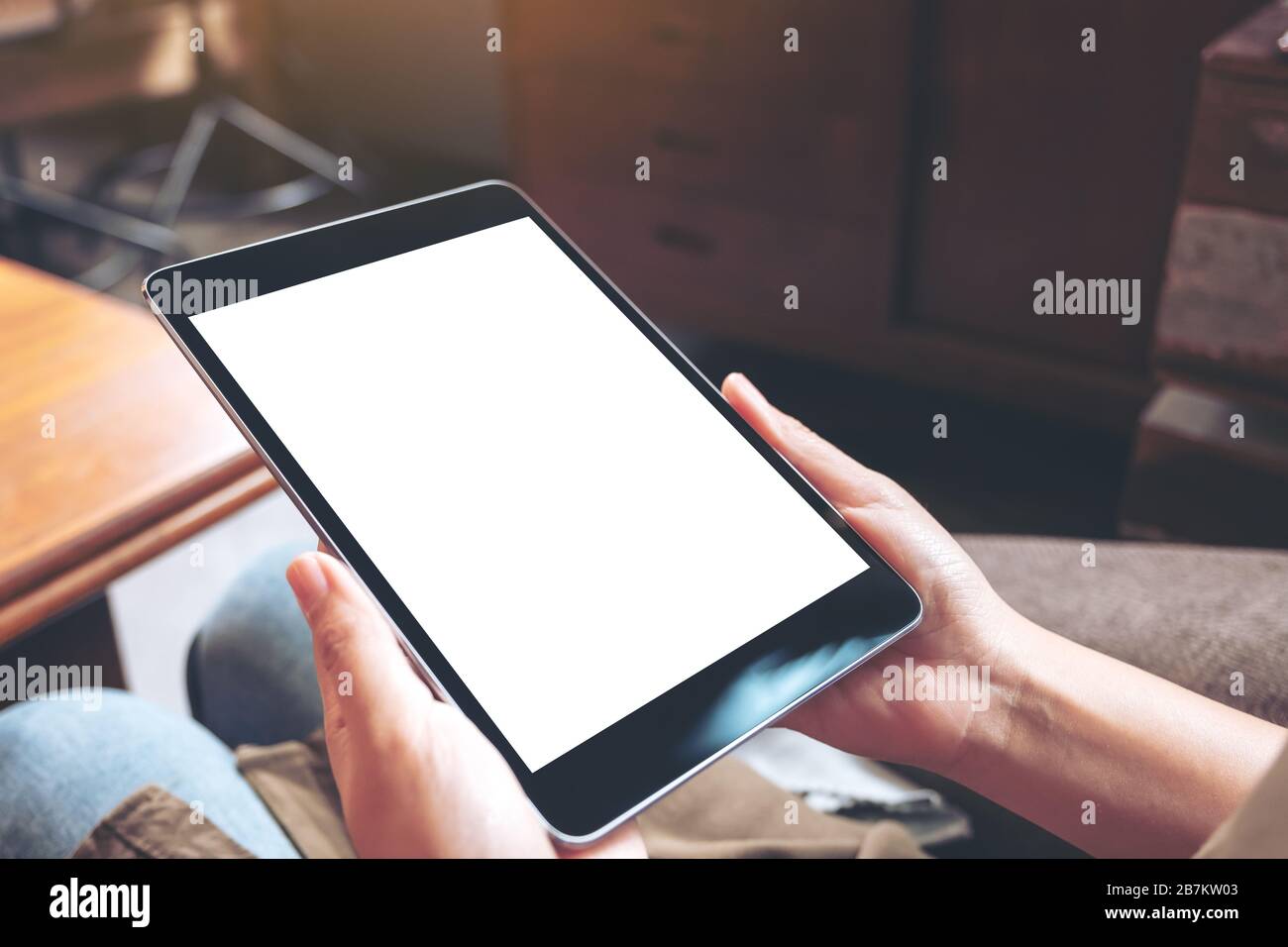 Mockup image of woman's hands holding black tablet pc with blank white ...