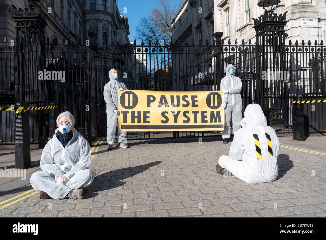 Beijing, China. 16th Mar, 2020. Activists stage a protest outside 10 Downing Street against the British government's handling of the COVID-19 outbreak in London, Britain on March 16, 2020. British scientists have urged the government to take 'more restrictive measures' to tackle the novel coronavirus. Credit: Ray Tang/Xinhua/Alamy Live News Stock Photo