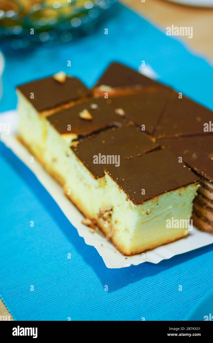 Vertical closeup shot of pieces of chocolate and cheese cake on a paper plate Stock Photo