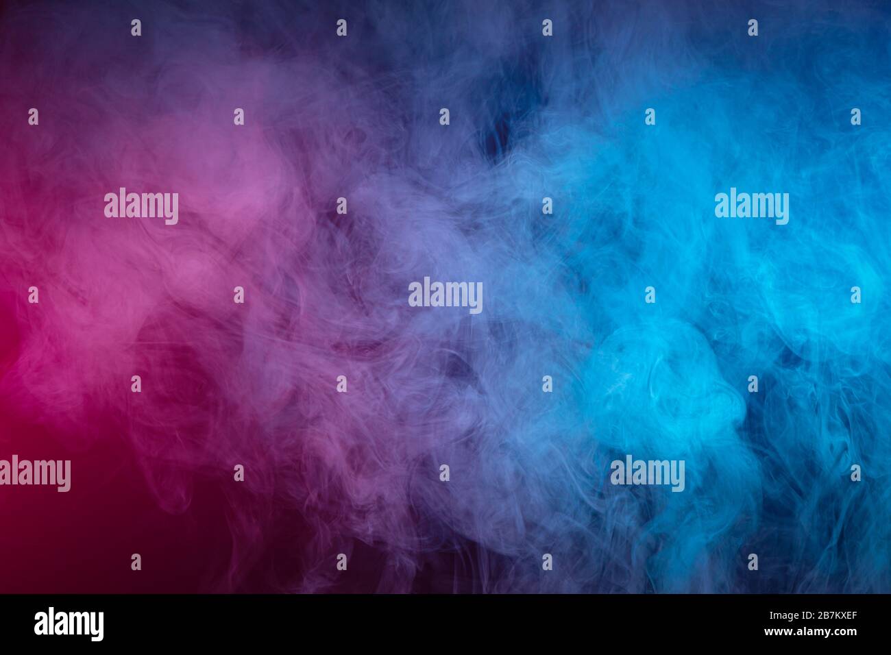 Blue and pink bomb smoke on black isolated background Stock Photo - Alamy
