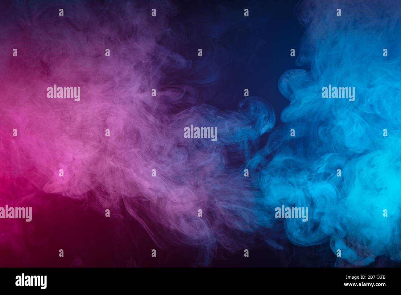 Blue and pink bomb smoke on black isolated background Stock Photo - Alamy