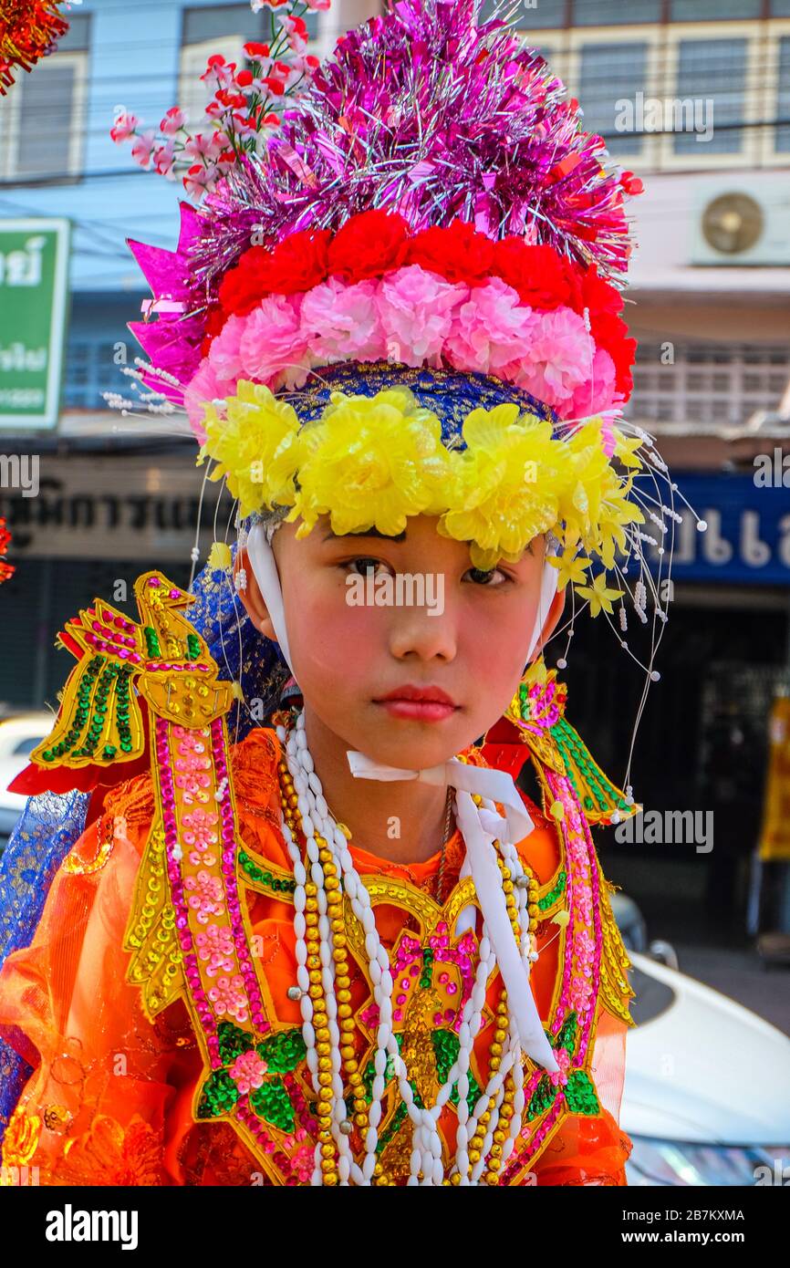 Chiang Mai, Thailand - April 5, 2018. Poy Sang Long, an annual Shan ordination ceremony. Young boy carried on the shoulders of a relative. Stock Photo