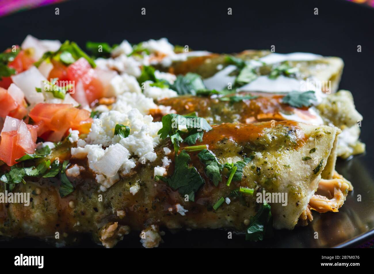 Enchiladas Verdes, or green enchiladas, tortillas filled with chicken