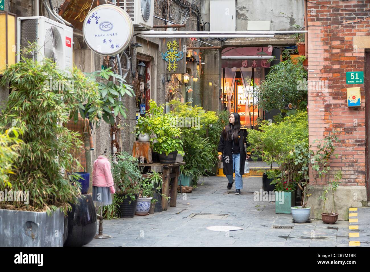 Woman walking around alleyways of Tianzifang, Shanghai, China Stock Photo