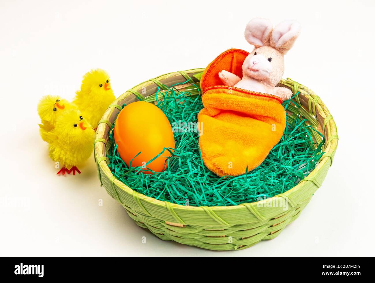 Easter bunny made of fabric in a sleeping bag in the Easter basket Stock Photo