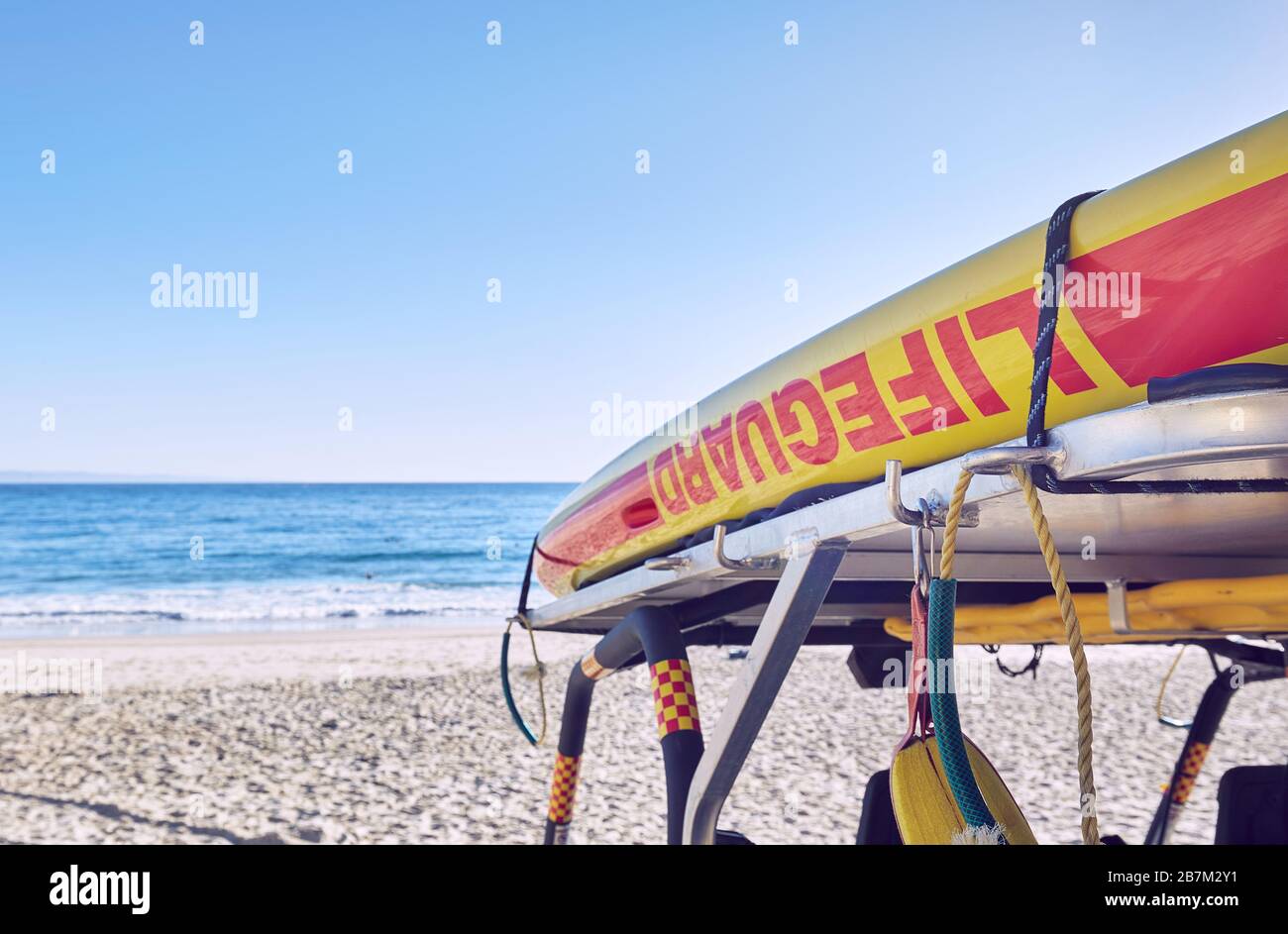 Lifeguard equipment in early morning light on a deserted Main Beach at Noosa, Queensland, Australia Stock Photo