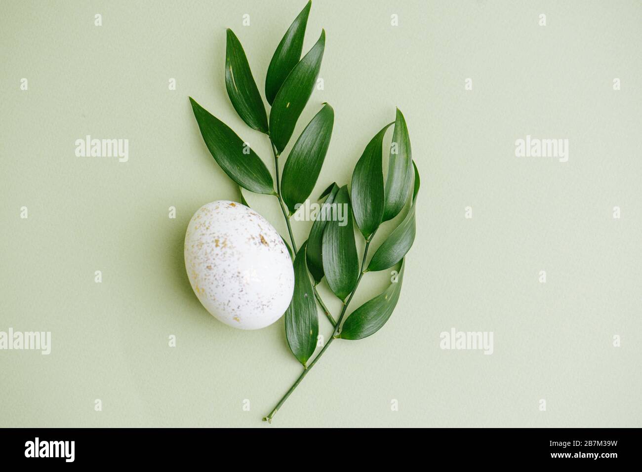 Easter egg, decoration with gold particles and leaf Stock Photo