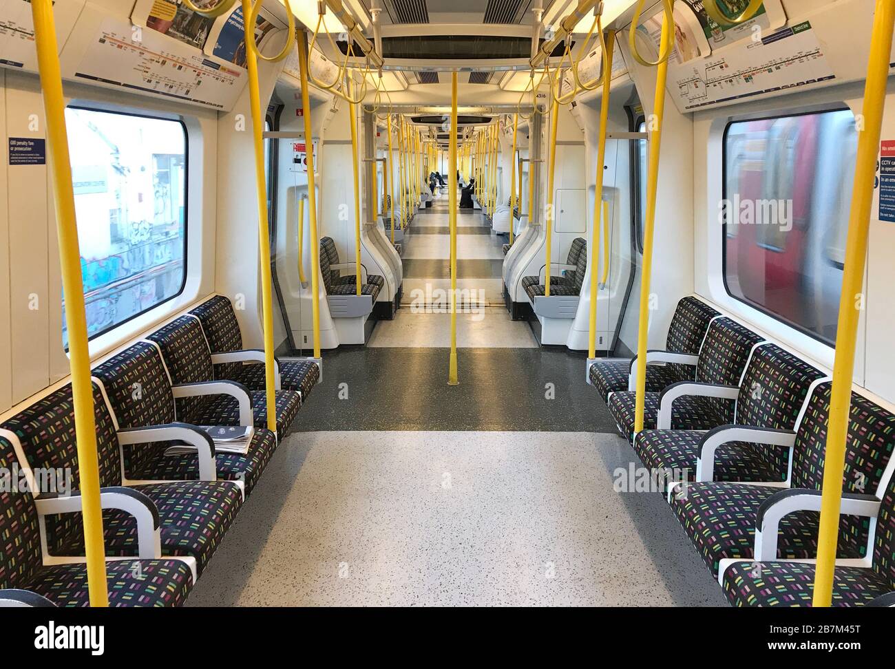 A sparsely-filled carriage on an Underground train in west London the day after Prime Minister Boris Johnson called on people to stay away from pubs, clubs and theatres, work from home if possible and avoid all non-essential contacts and travel in order to reduce the impact of the coronavirus pandemic. Stock Photo