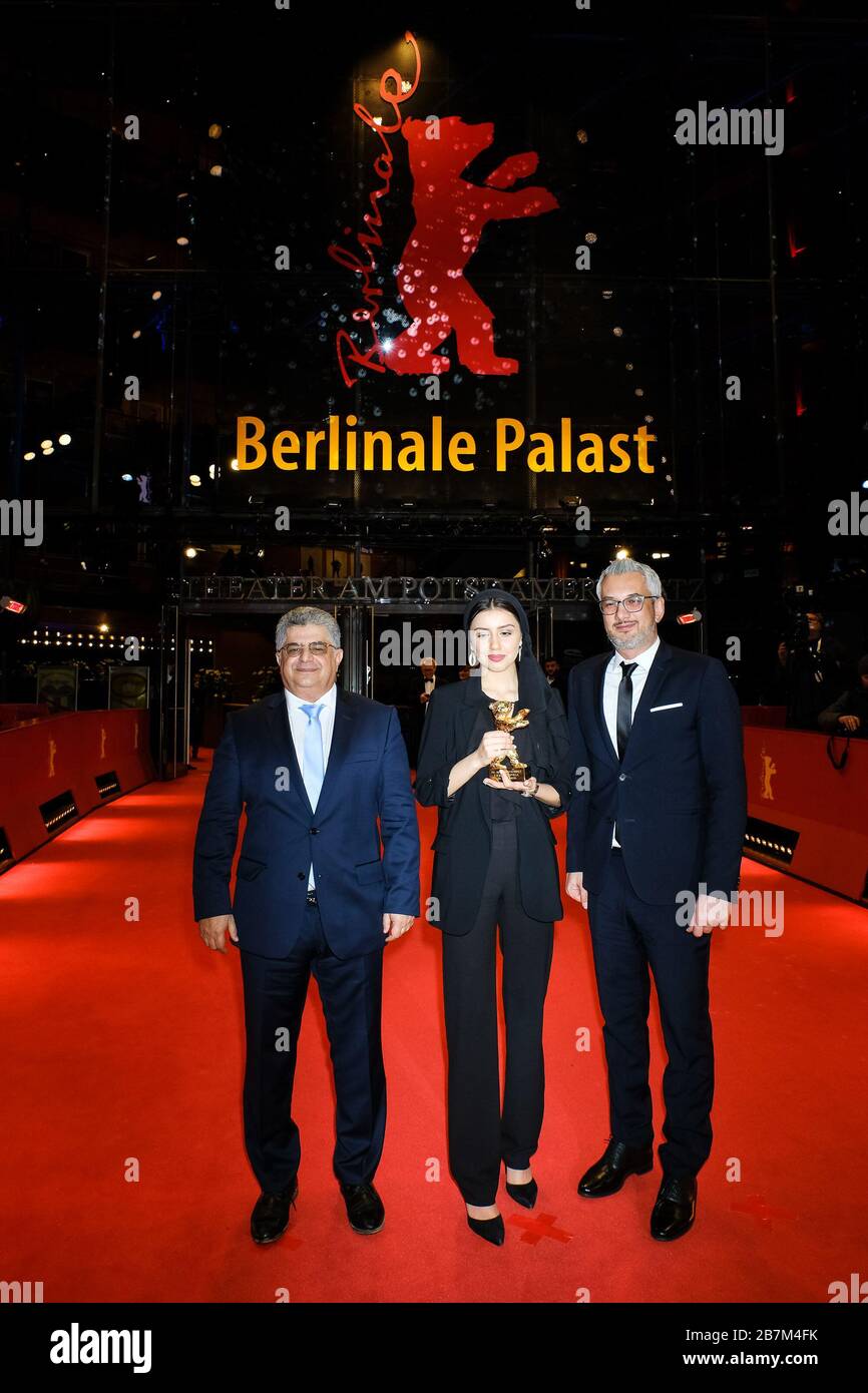 Baran Rasoulof on behalf of her father, director and producer Mohammad Rasoulof with producers Farzad Pak & Kaveh Farnam poses with their award Golden Bear for Best Film  on the Red Carpet at the Closing Ceremony and Awards for the 70th Berlin International Film Festival ( Berlinale ) on Saturday 29 February 2020 at Berlinale Palast, Potsdamer Platz, Berlin. . Picture by Julie Edwards. Stock Photo
