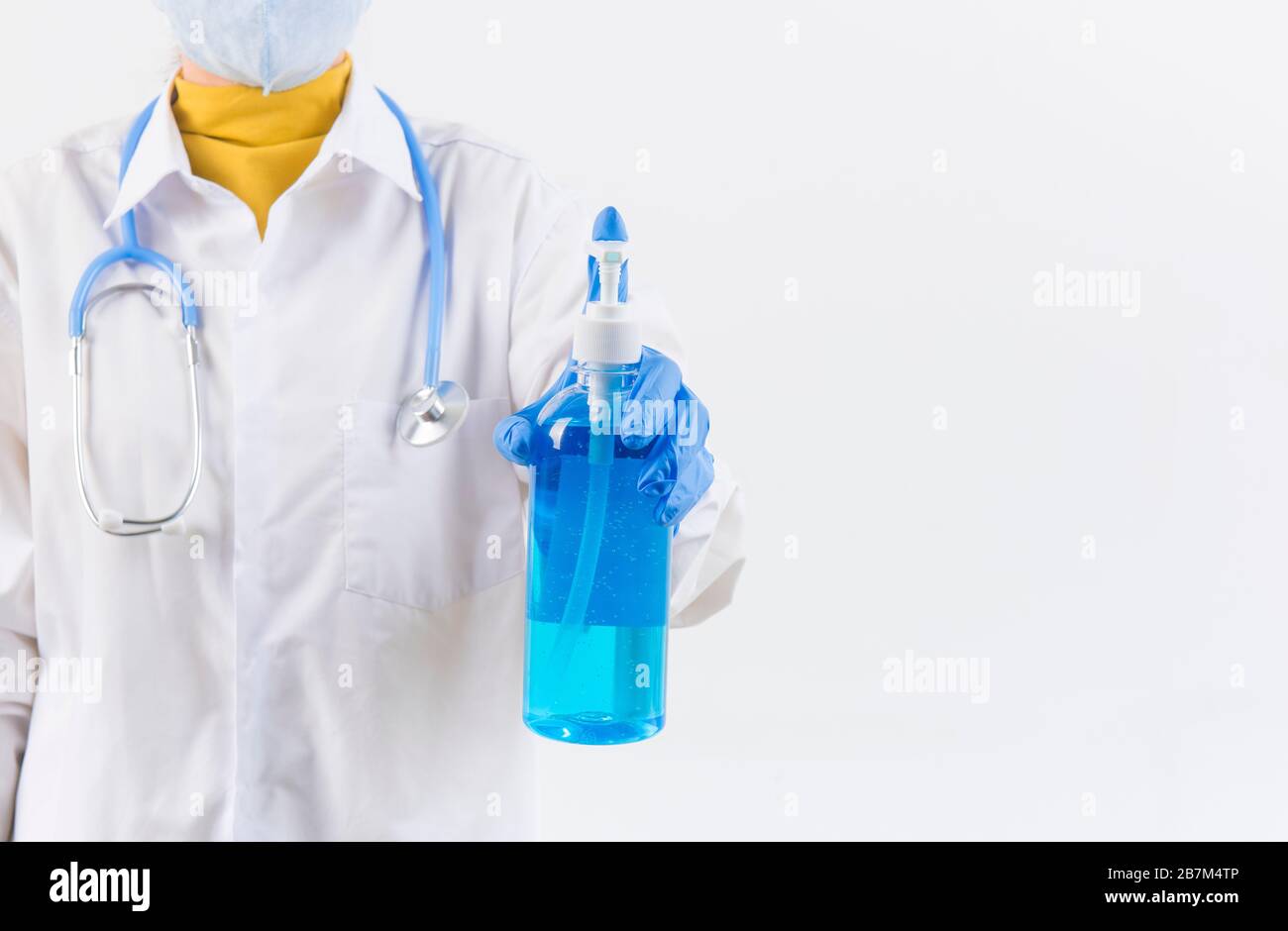 Doctor hands using washing hand with Alcohol Sanitizer and dust mask isolate on a white background. Protect themselves from virus infection in Corona Stock Photo