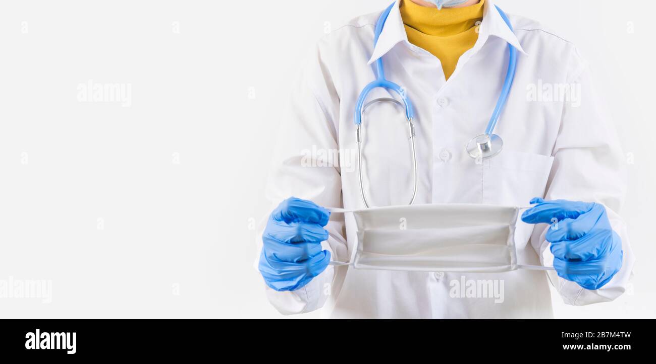 Doctor hand holding a dust mask, 2.5 isolate on a white background. Promoting people use face mask to protect themselves from virus infection in Coron Stock Photo