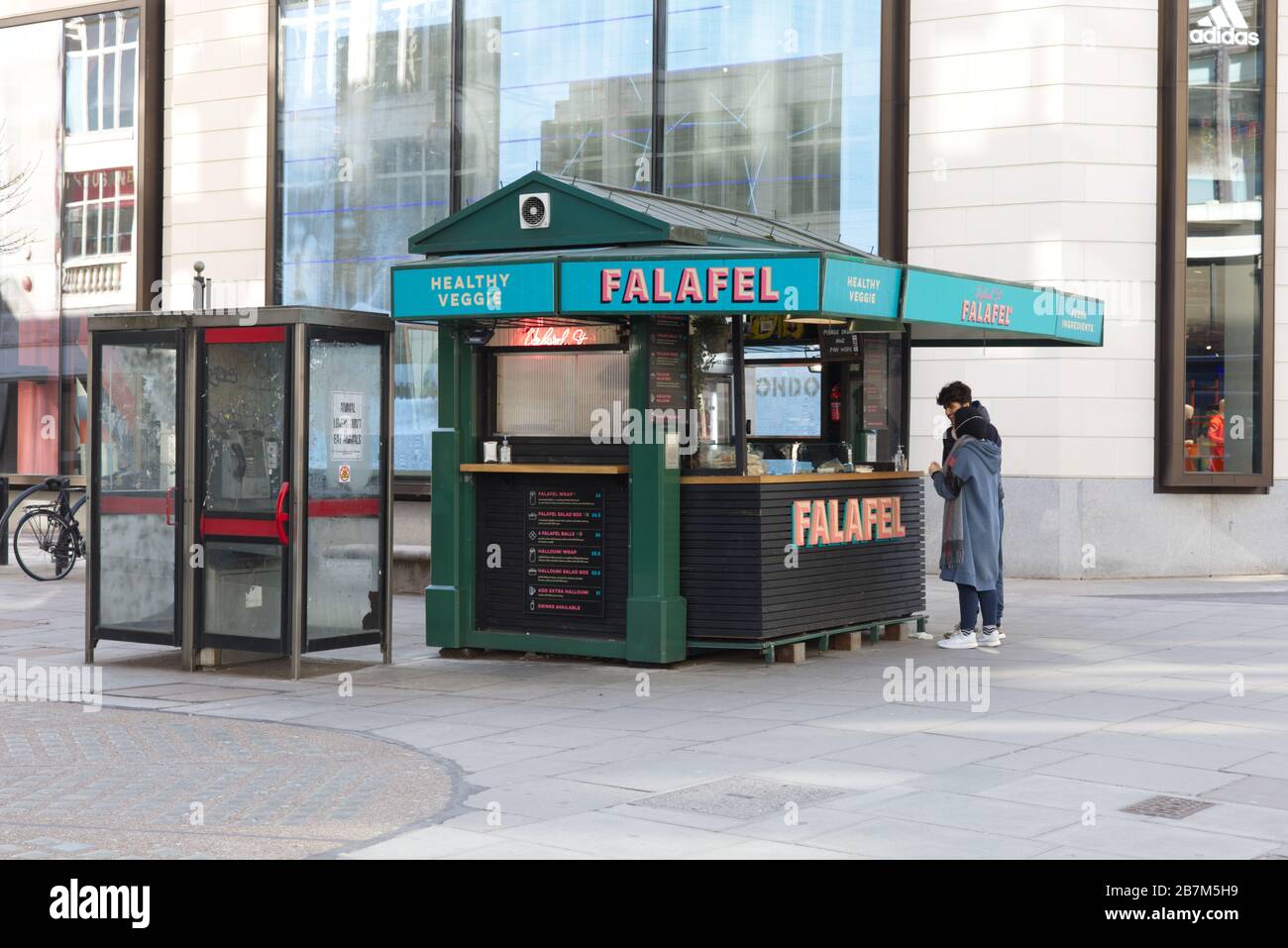 masked people at the Falafel kiosk, Oxford street london Stock Photo