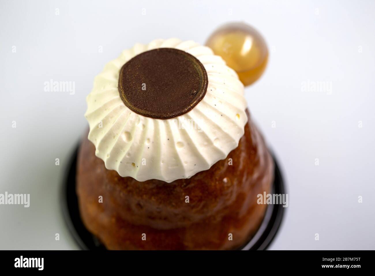 Rum baba with rum,chocolate disc and chantilly cream Stock Photo Alamy