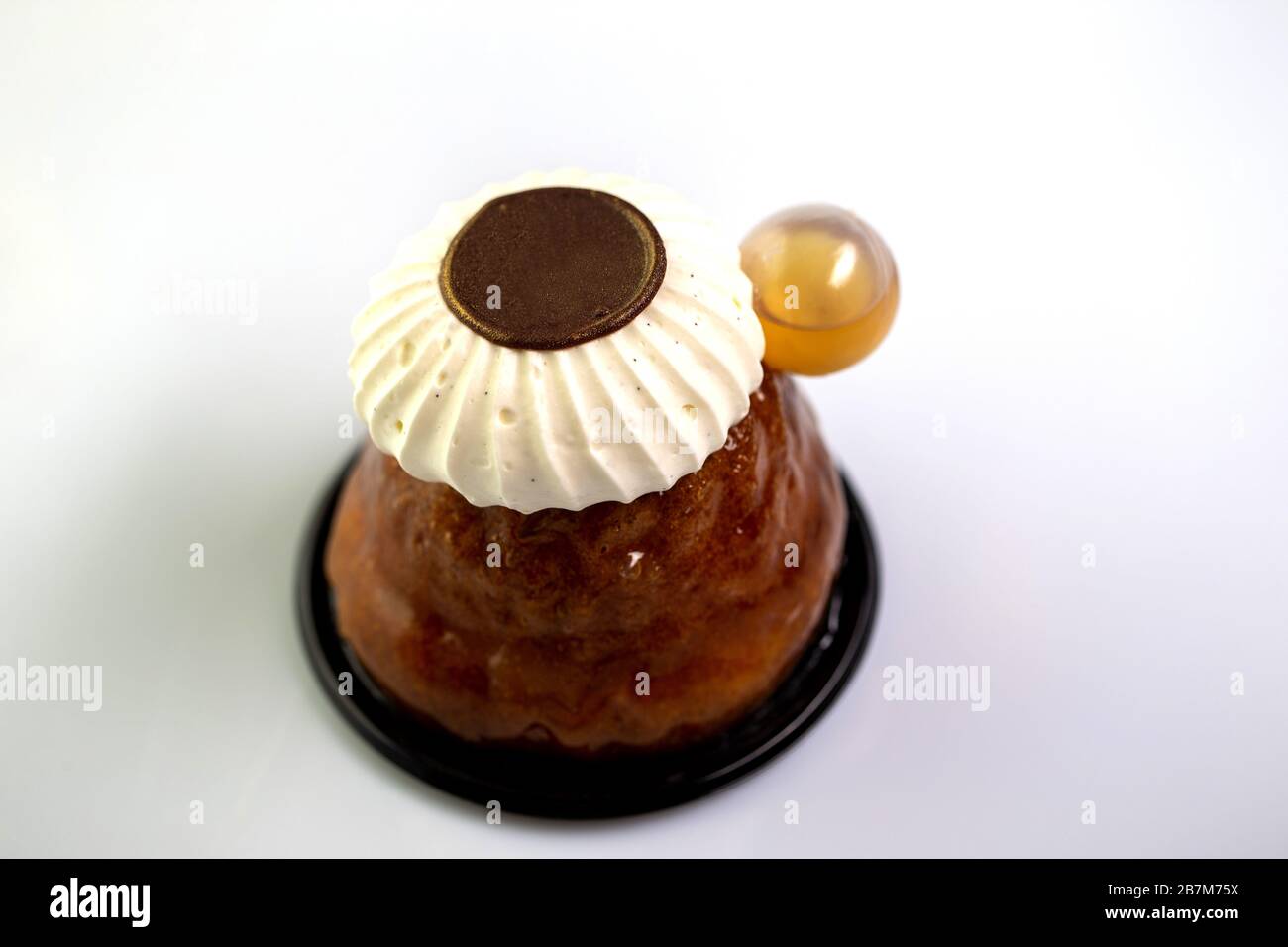 Rum baba with rum,chocolate disc and chantilly cream Stock Photo Alamy