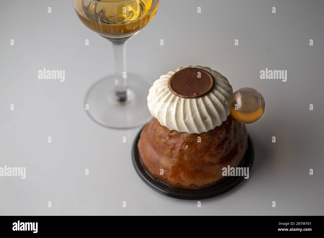 Rum baba with rum,chocolate disc and chantilly cream Stock Photo Alamy