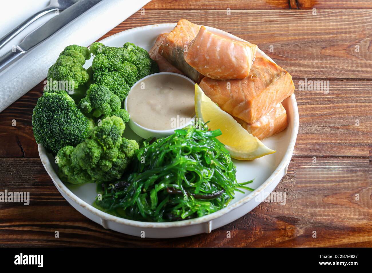Steamed salmon with broccoli and seaweed salad. Diet healthy eating. On