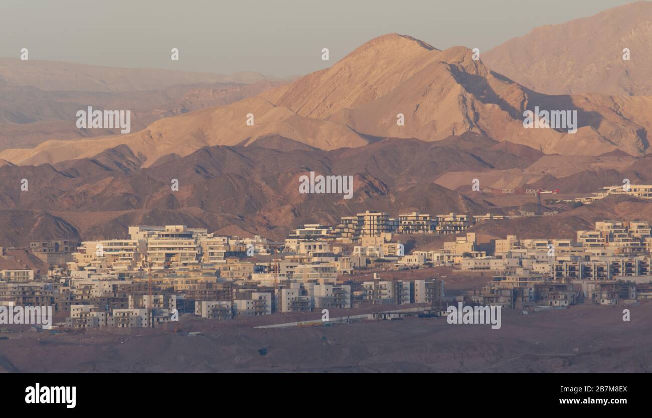 Landscape photograph of the suburb of Ayla in Aqaba in Jordan and the Gulf of Aqaba at sunrise Stock Photo