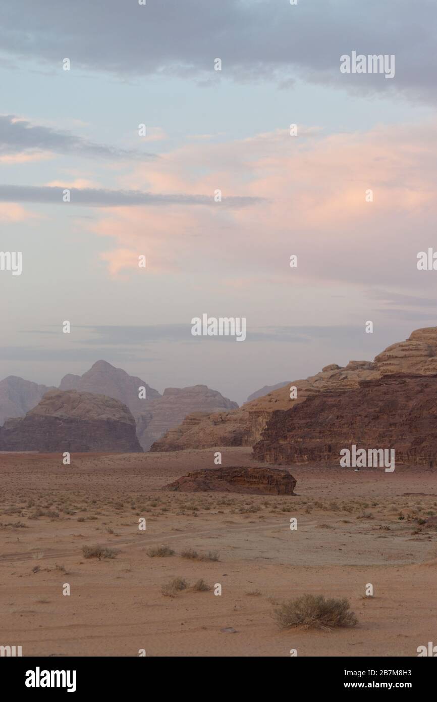 Portrait photograph of Wadi Rum after sunset with pink clouds Stock Photo