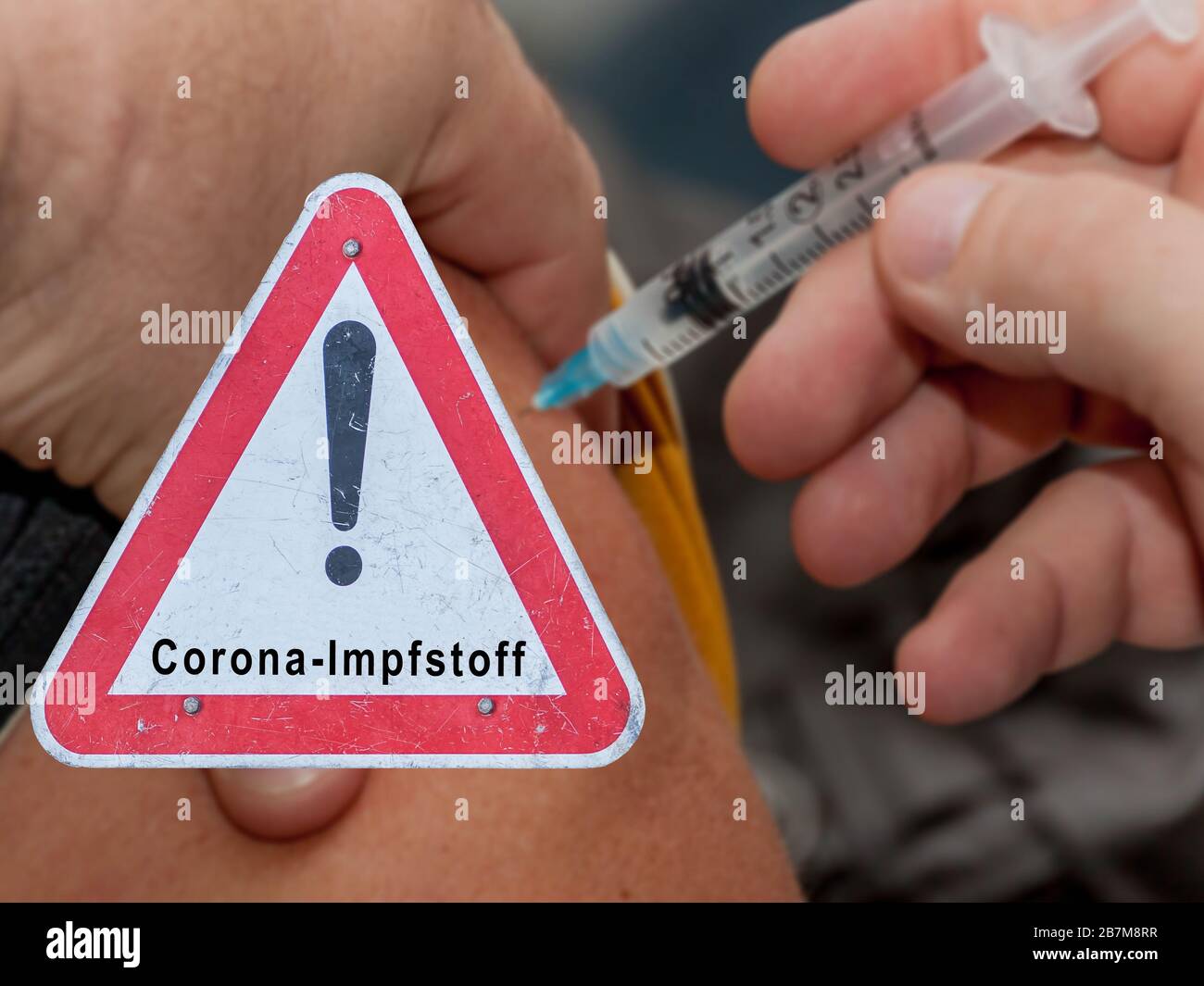 Corona vaccine warning sign symbolic in german Stock Photo