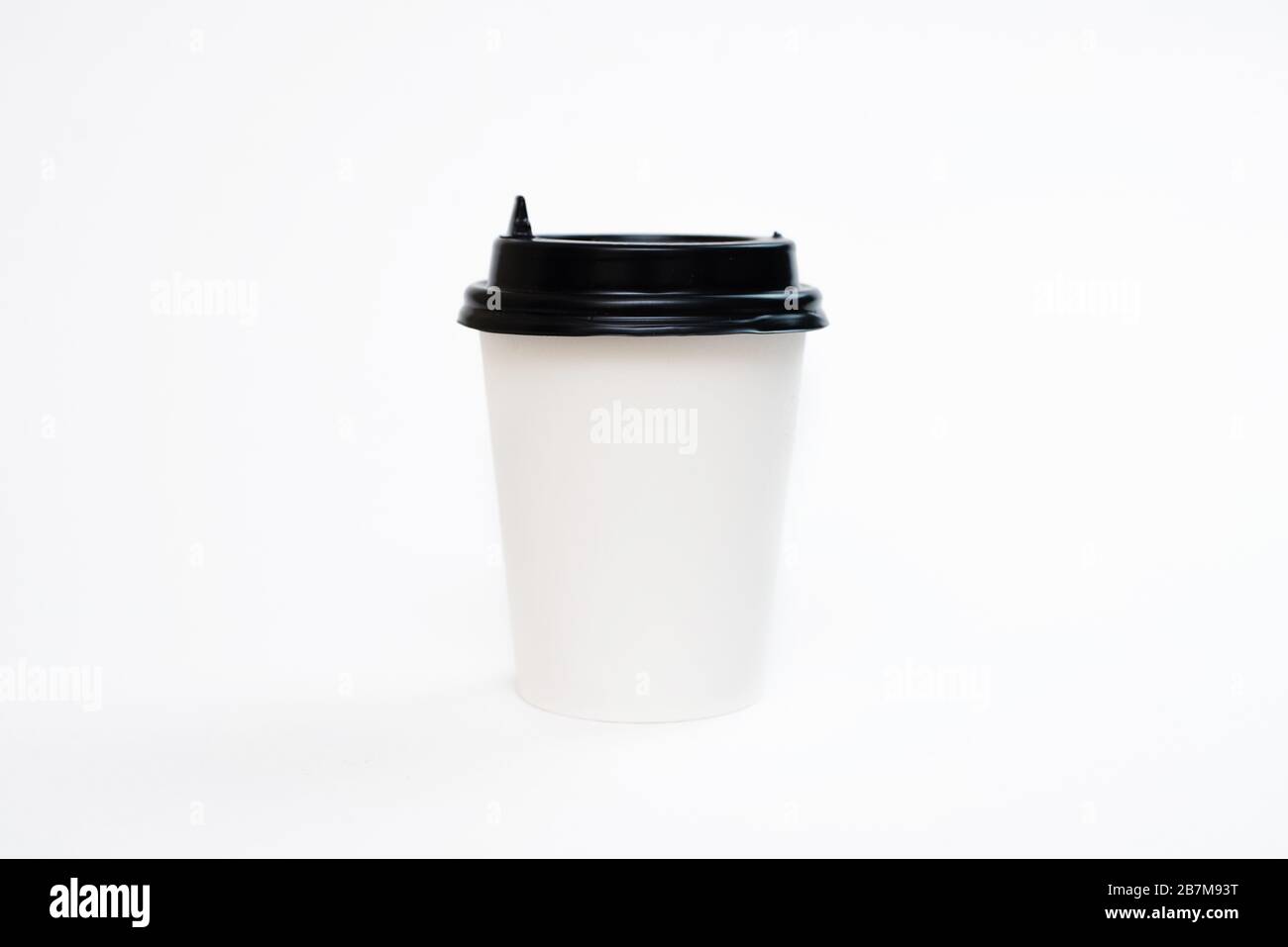 Coffee in a cardboard cup on a white background isolation. Top view, flat lay Stock Photo