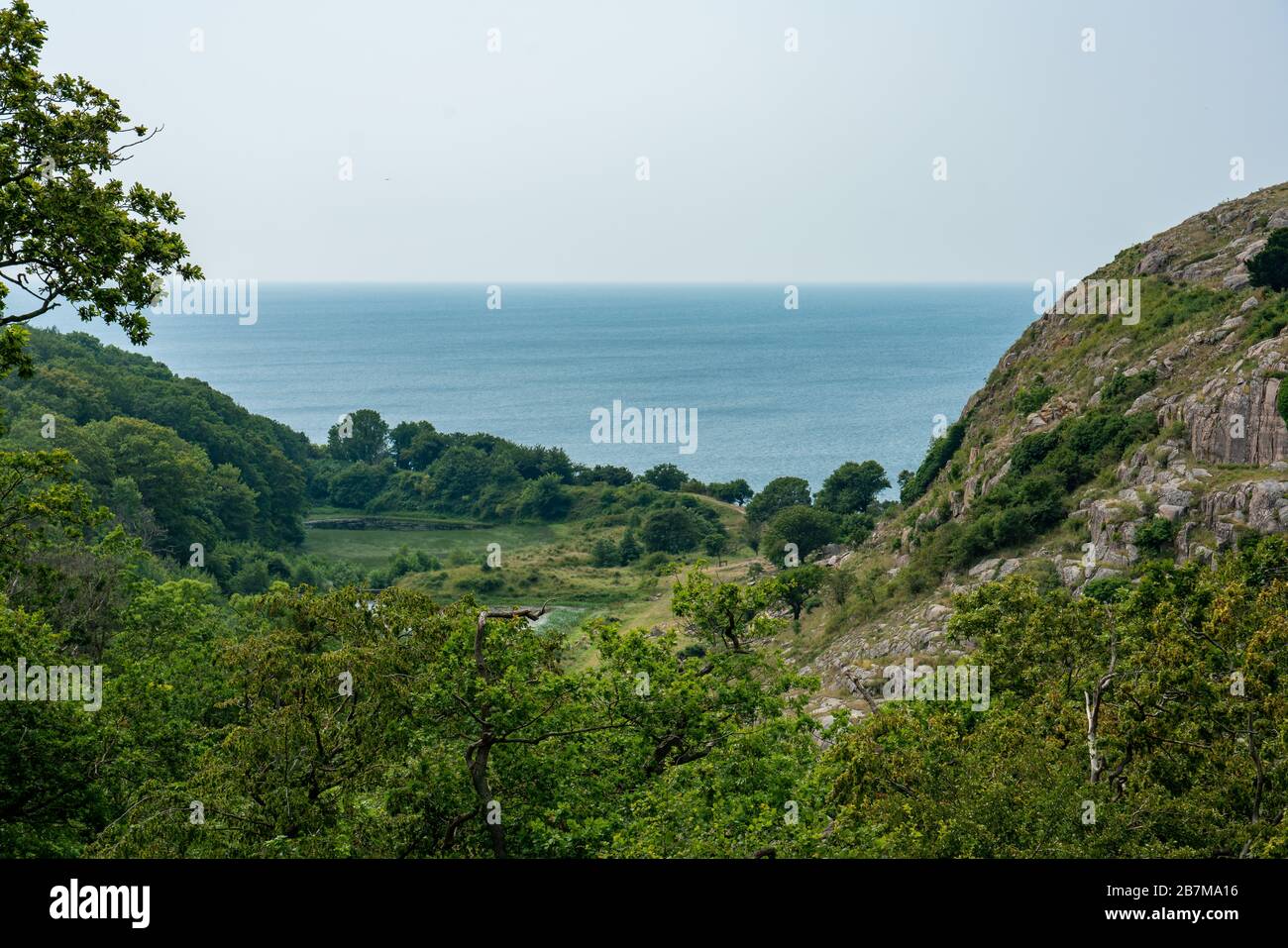 Hammershus, Bornholm / Denmark - July 29 2019: Valley with Baltic Sea in the back. Stock Photo