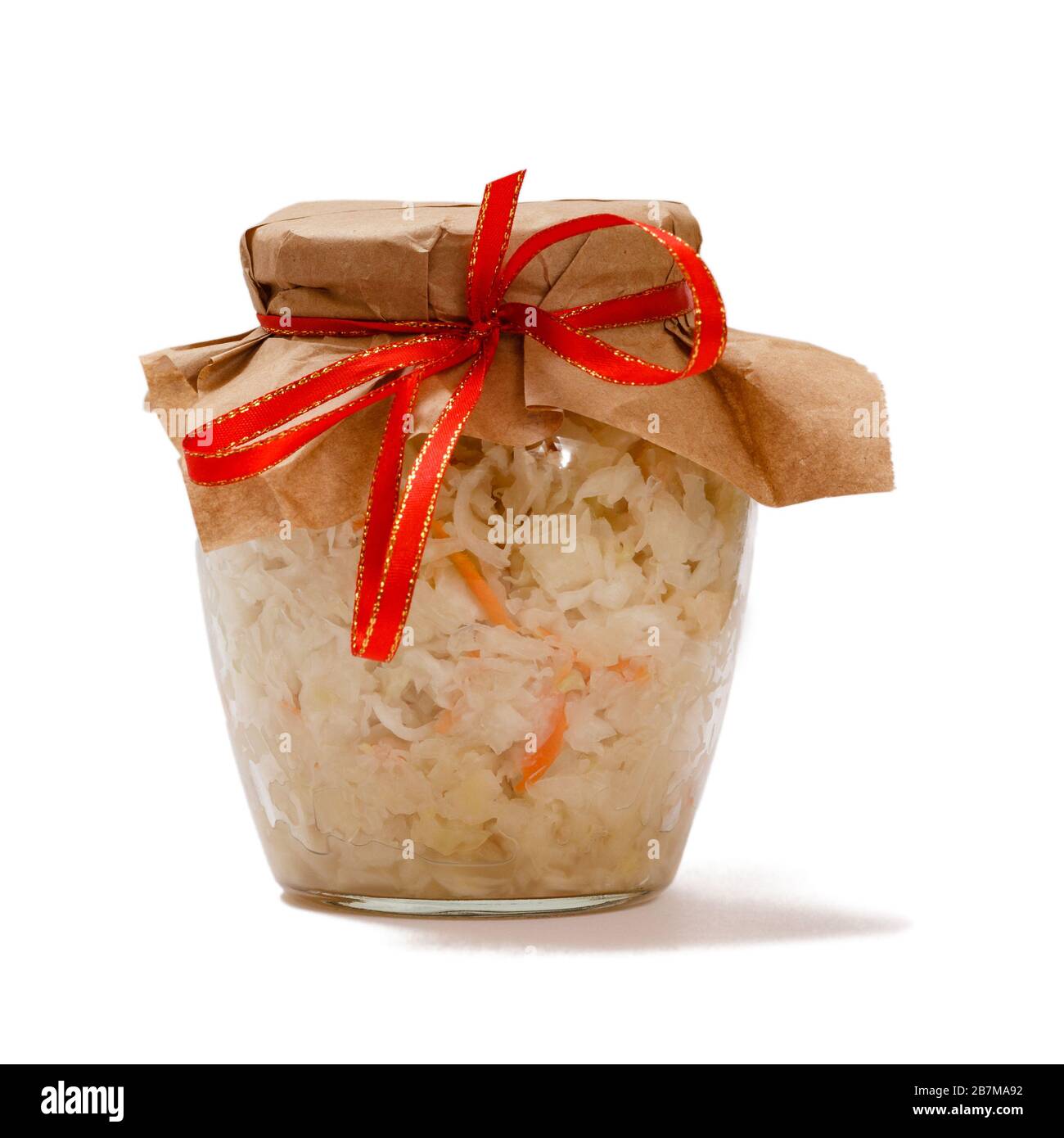 Homemade fermented cabbage with carrot in glass jar on white isolated background. Vegan salad. Dish is rich in vitamin U. Food great for good health. Stock Photo