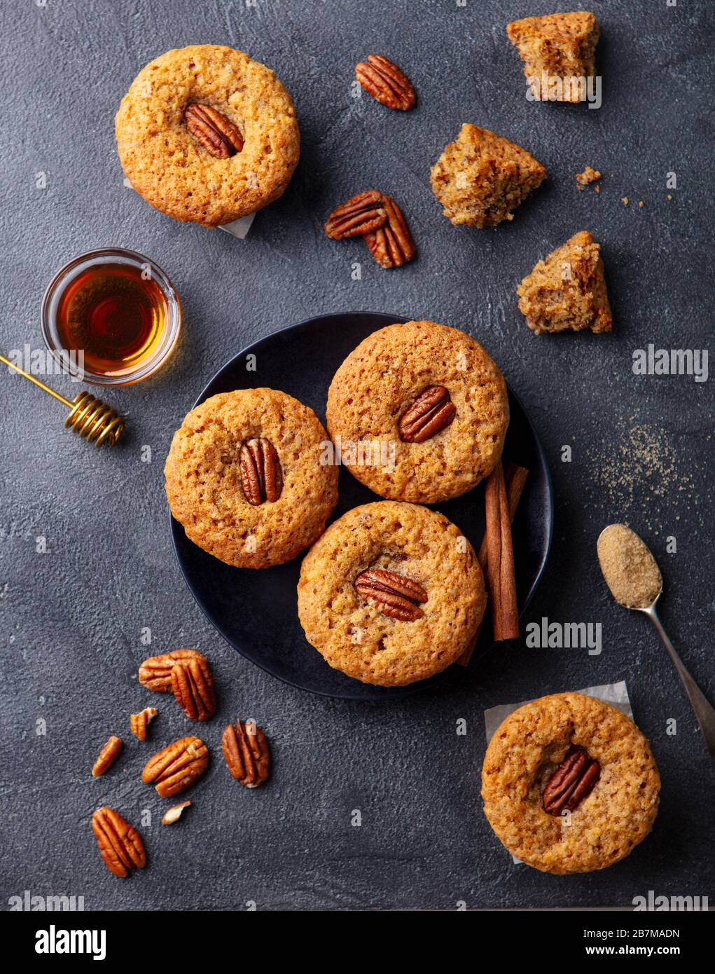 Pecan nut muffins on a plate. Grey background. Top view. Stock Photo