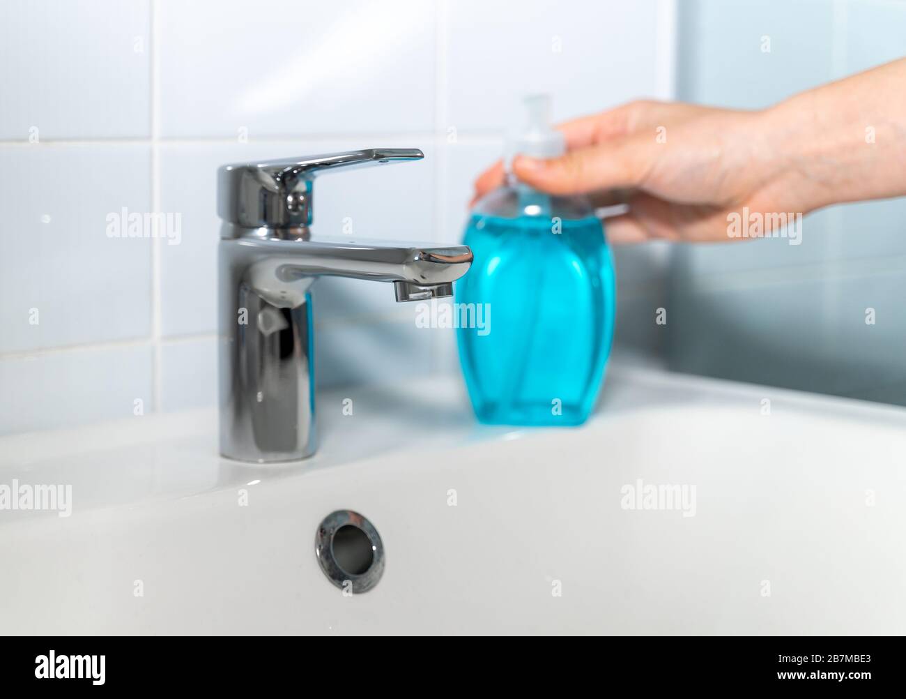 Woman washing her hands at home with antibacterial soap Stock Photo - Alamy