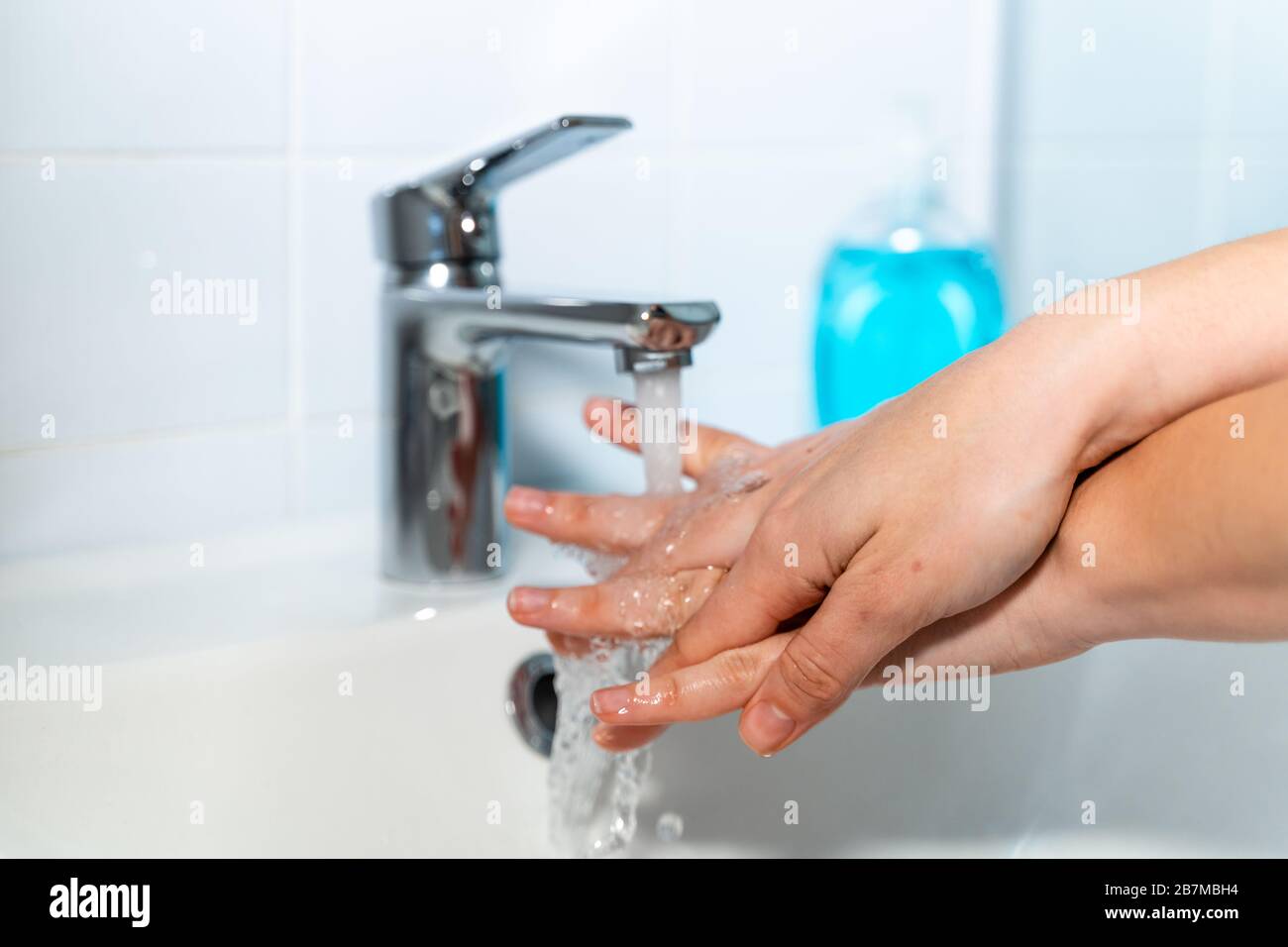 Woman washing her hands at home with antibacterial soap Stock Photo - Alamy