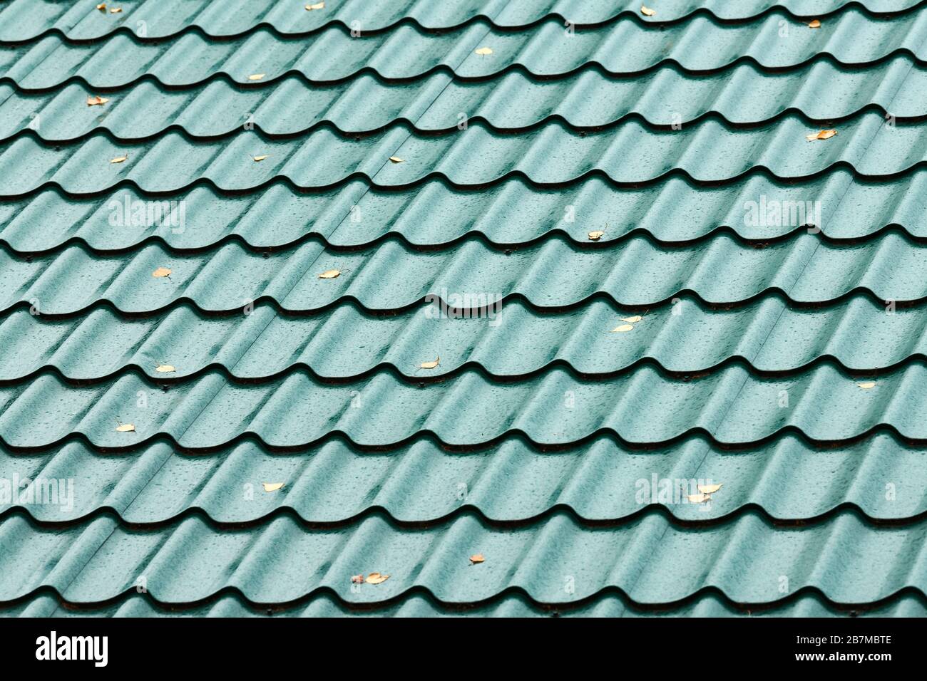 Modern green roof tile pattern. Reliable house rooftop cover against