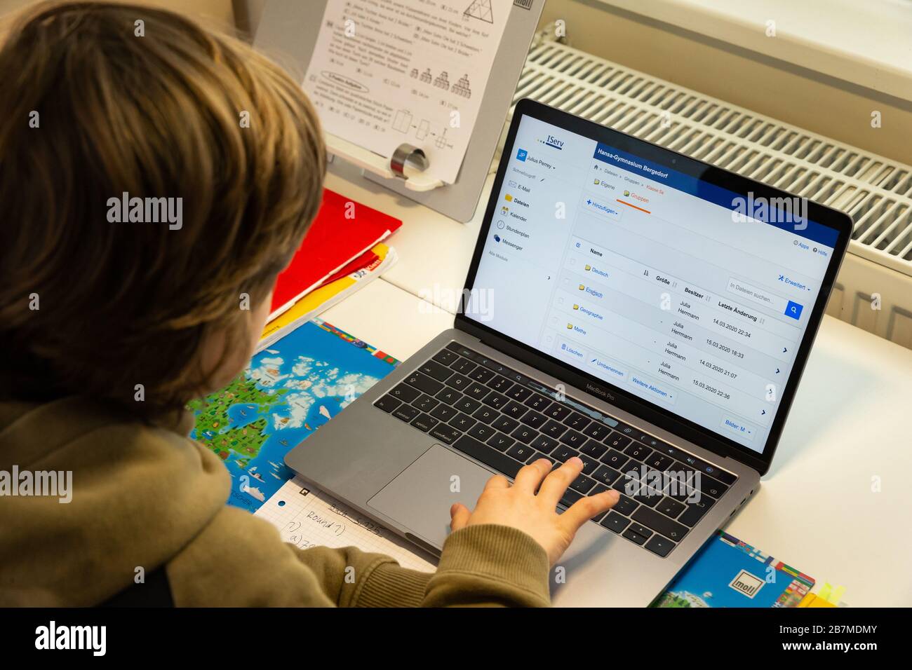 Wentotf Bei Hamburg, Germany. 16th Mar, 2020. Julius, an eleven-year-old grammar school pupil, solves tasks in his children's room in Wentorf near Hamburg that his teachers have sent him via the school server for each day. Because of the corona virus, all schools and daycare centres in the Hanseatic city are closed. Credit: Ulrich Perrey/dpa/Alamy Live News Stock Photo