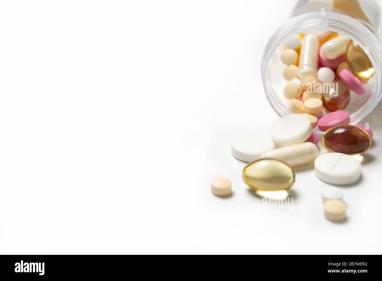 A lot of different pills in a jar on a white background. The medicine. Medication Stock Photo