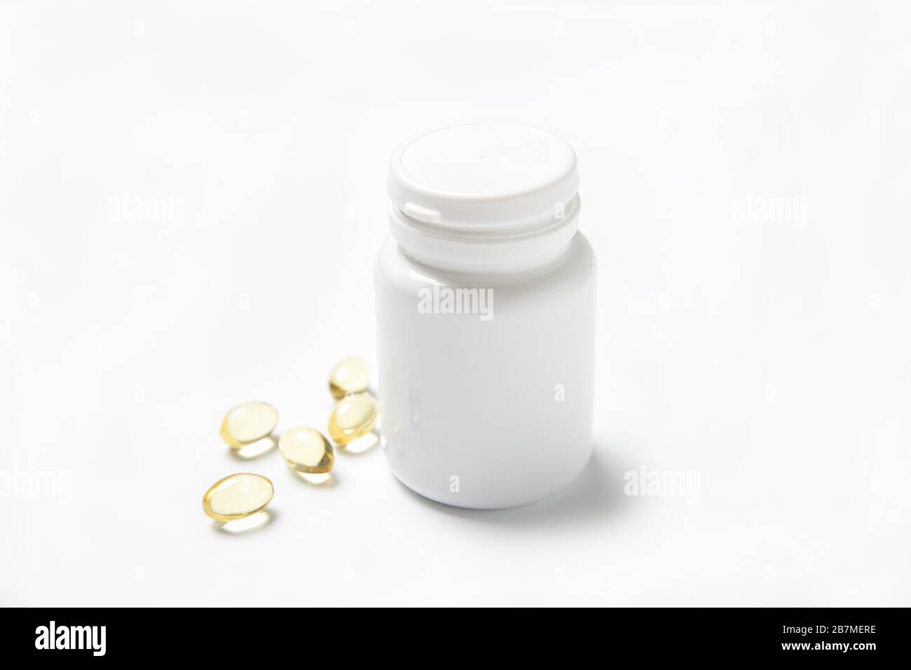 Fish oil pills in a jar on a white background. Omega 3. Vitamins Stock Photo