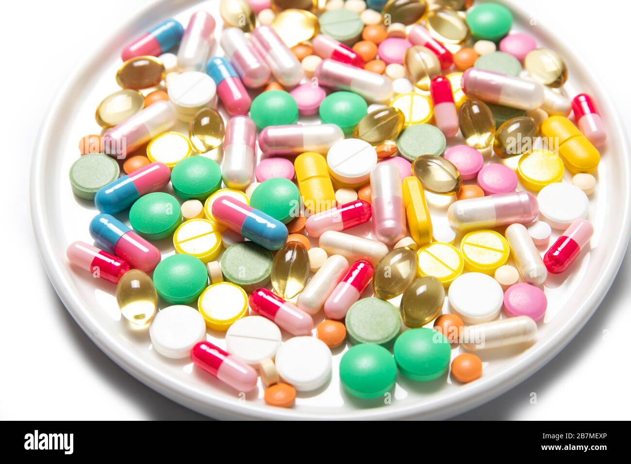 Pills lie in a white plate close-up. Health, medicine Stock Photo