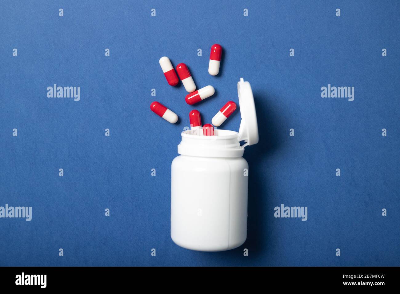 Jar with pills on a blue background. Concept of medicine and health Stock Photo